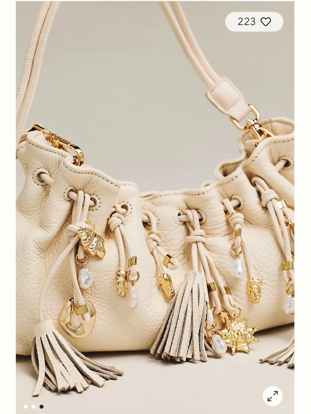 Dolce Vita Cream Tassel Drawstring Crossbody Bag with Gold Charms